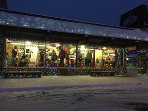Outdoor Ventures - A Lure of Lights snow covered streets & store front view